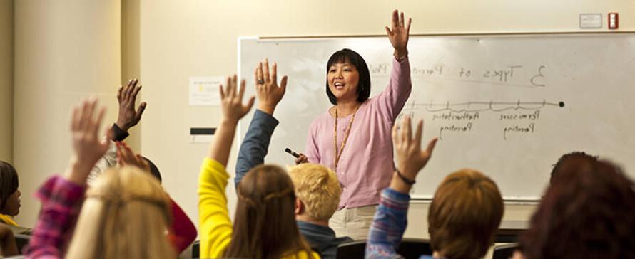 Prof. Lena Shiao speaking before a class of students.